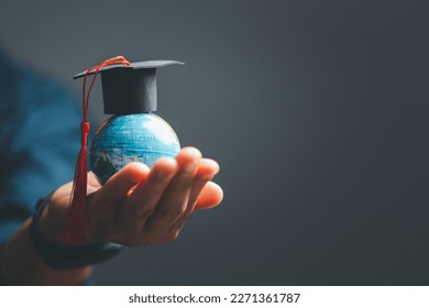 Graduation cap with Earth globe. Concept of global business study, abroad educational, Back to School. Education in Global world, Study abroad business in universities in worldwide. language study - Powered by Shutterstock