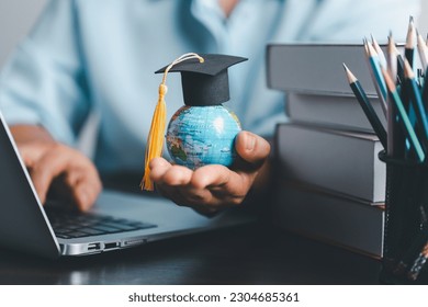 Graduation cap with Earth globe. Concept of global business study, abroad educational, Back to School. Education in Global world, Study abroad business in universities in worldwide. language study - Shutterstock ID 2304685361