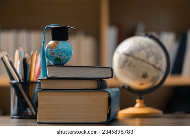 Graduation cap with Earth globe. Concept of global business study, abroad educational, Back to School. Education in Global world, Study abroad business in universities in worldwide. language study - Shutterstock ID 2349898783