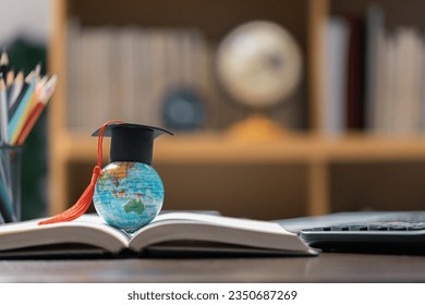 Graduation cap with Earth globe. Concept of global business study, abroad educational, Back to School. Education in Global world, Study abroad business in universities in worldwide. language study - Powered by Shutterstock - Get 15% off with code: PIKWIZARD15