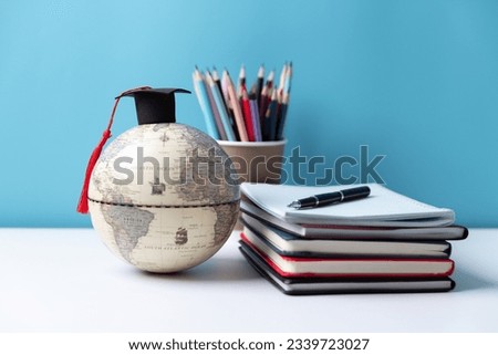 Graduation cap with Earth globe. Concept of global business study, abroad educational, Back to School, Study abroad business in universities. Elements of this image furnished by NASA.