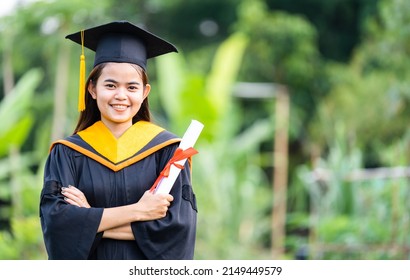 Graduation Cap With Gold Tassel Holding A Diploma Success Graduates Of The University,Concept Education Congratulation Graduates In University.