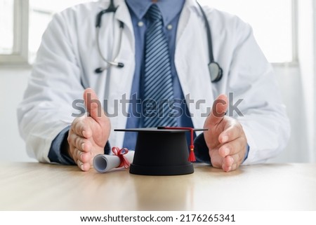 Graduation cap in hand of doctor, medical education course degree concept.