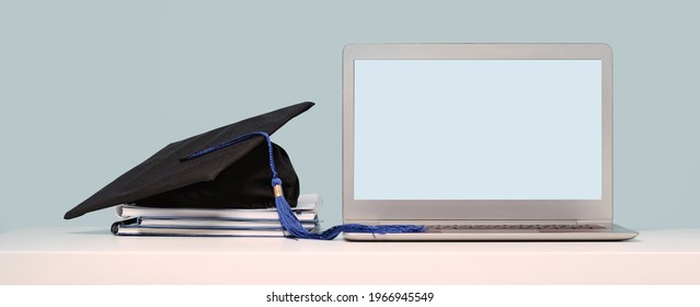 Graduation Cap On Notebooks Near Laptop. Masters Or Bachelors Degree Thesis Writing. Knowledge Online Courses Qualifications And Higher Education With Copy Space. Lockdown. Mock Up Screen