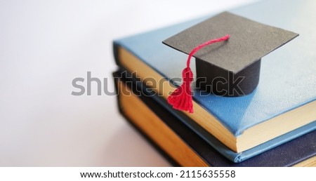 Graduation cap on stack of books. University degree concept 