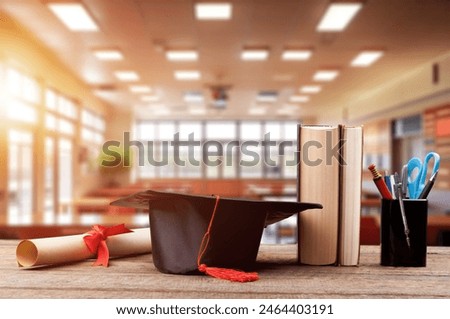 A Graduation cap on stack of books on the table.