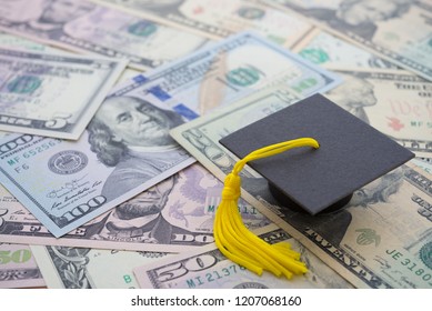 Graduation Cap University Or College Degree On US Dollars Banknotes Background. Education Expense Budget Plan Of Money Saving, Loan, Debt, Personal Loan, Scholarship For Studying Abroad Concept.