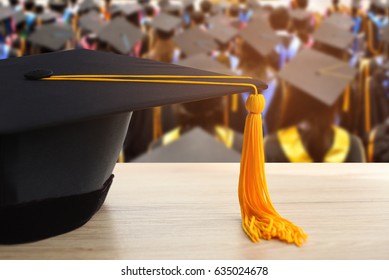 graduation cap with Yellow tassel on wood table background