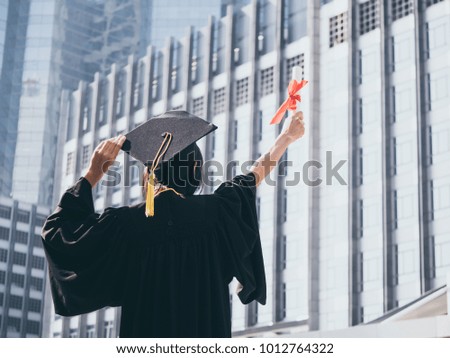 Graduation day, Back view of Asian woman with graduation cap and gown holding diploma, Successful concept
