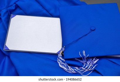 Graduation Day. Cap, Gown And Blank Diploma With Copy Space For Personalized Text Or Message. 