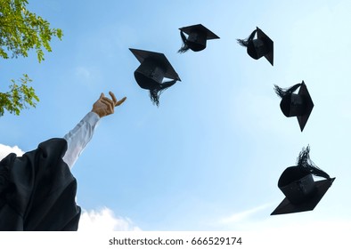 Graduation Day, Images Of Hand Holding Caps Or Hat Throwing In The Air With Sunshine Day On Blue Sky Background, Happiness Feeling, Commencement Day, Congratulation, Ceremony.