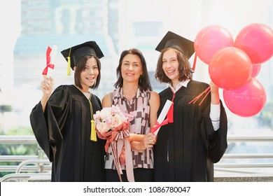 graduation day university woman and family, girl hold diploma and balloon congratulations on the graduation day.
