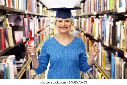 Graduation, Education And Old People Concept - Happy Senior Graduate Student Woman In Mortar Board With Diploma Over Library Background