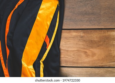 Graduation Gown On Old Wood Background