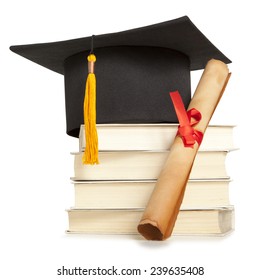 Graduation hat, book and diploma isolated on white
