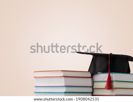 Graduation hat and stack of study books