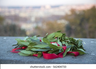 Graduation Laurel Wreath With Red Ribbon Laying On A Granite Slab With A View To Rome City (out Of Focus)