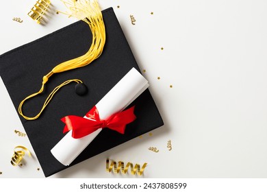 Graduation party concept. Flat lay square academic cap with diploma and gold tinsel on white background. - Powered by Shutterstock