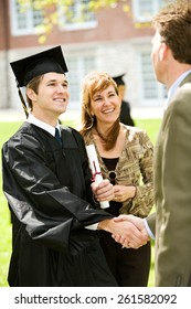 Graduation: Teacher Congratulates New Graduate