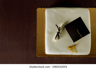 Graduation White Cake With Cap On The Top And Diploma Decor. Top View.