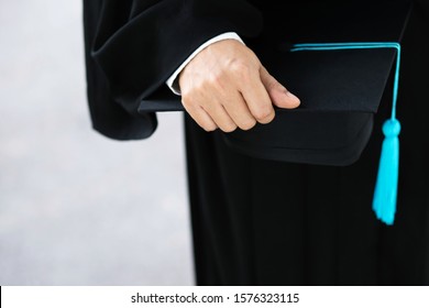 Graduation,close Up Student Holding Hats And Tassel Blue In Hand During Commencement Success Graduates Of The University,Concept Education Congratulation.Graduation Ceremony.