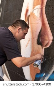 Graffiti Artist Making Mural On The Street