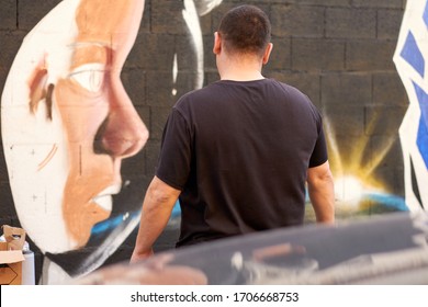 Graffiti Artist Making Mural On The Street