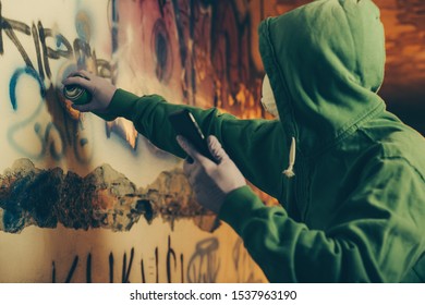 Graffiti Artist Painting With Aerosol Spray.