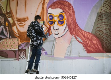 Graffiti Artist Painting On The Wall