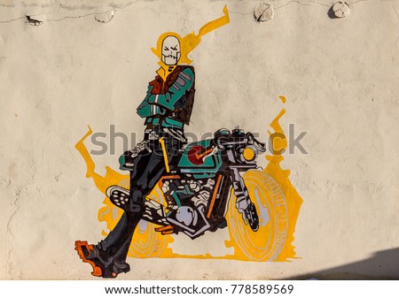 The graffiti of ghost rider with his bike on a wall of a cafe in Ladakh, India. Natural beauty of Ladakh in India. Snow mountains of Ladakh. Famous tourist place in the world. Travel Photography. 
