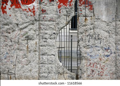 Graffiti And Greetings On One Of The Remaining Sections Of The Old Cold War Berlin Wall - Germany. This Section With A Big Hole To Freedom.