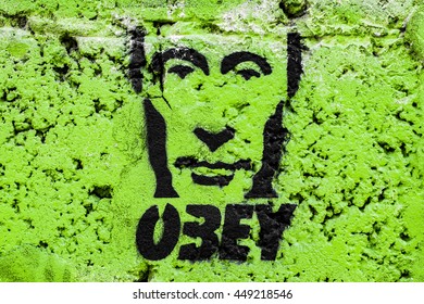 Graffiti on the wall, obey Putin on a green background - Powered by Shutterstock