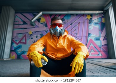 Graffiti painter rest near the wall with his paintings looking to camera. Street art concept - Powered by Shutterstock