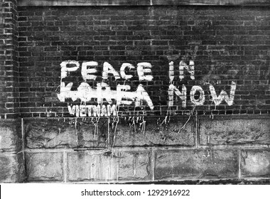 Graffiti, Peace Now. Korea, Vietnam. Brick Wall.