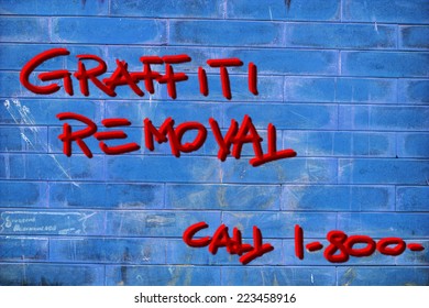 Graffiti Removal Writing On A Blue Wall