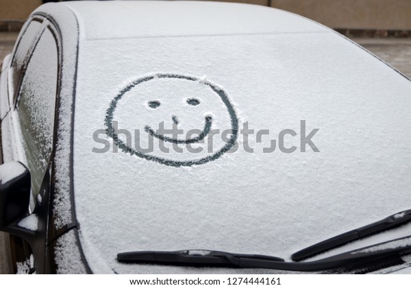 graffiti in snow on\
windscreen of car