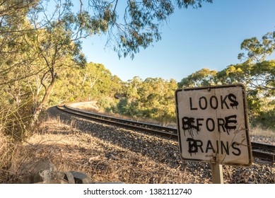 Graffitied warning sign at a railway crossing, Adelaide Hills, Australia