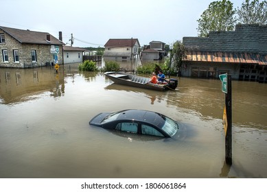 Grafton, Illinois, USA, June 1, 2019 -Car submerged under flood water in small river town, Grafton, Illinois, as Mississippi River floods roads, businesses and houses. vehicle under water, men in boat