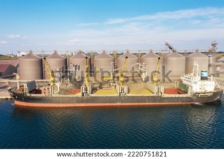 Grain agreement. Loading grain into holds of sea cargo vessel through an automatic line in seaport from silos of grain storage. Bunkering of dry cargo ship with grain