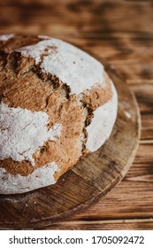 Grain Artisan Bread Loaf. Rustic Loaf Of Homemade Bread On Dark Wooden Table. Homemade Loaf Of Bread. Overhead View. Vertical Photo