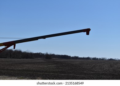 Grain Auger In A Farm Field