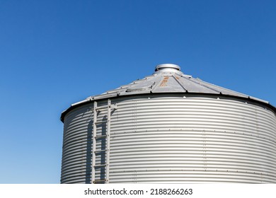 Grain Bin Storage System On Farm. Agriculture And Farming Equipment Safety, Maintenance, And Repair Concept