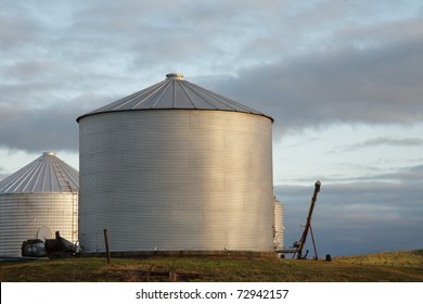 Grain bins against the morning sky