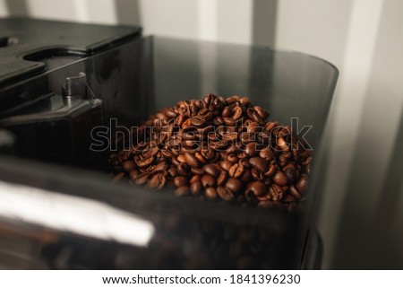 Grain coffee in a coffee machine. Aromatic coffee beans. Beautiful coffee beans.