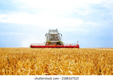 Grain combine harvesters working in wheat field. Agriculture background. Harvest season - Shutterstock ID 2188167525