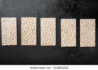 Grain diet light crisp bread  set, on black dark stone table background, top view flat lay, with copy space for text