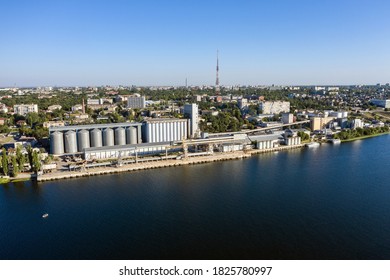 Grain elevator and silos near the river aerial view.