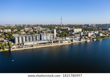 Grain elevator and silos near the river aerial view.