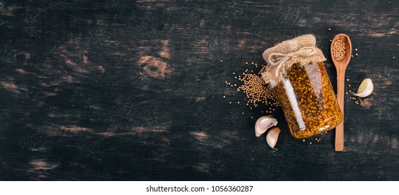 Grain Mustard. Spices On a dark wooden background. Top view. Copy space for your text. - Shutterstock ID 1056360287