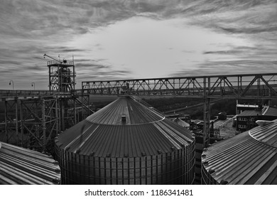 Grain Silo And Dryer At Night With Pile Of Grain.